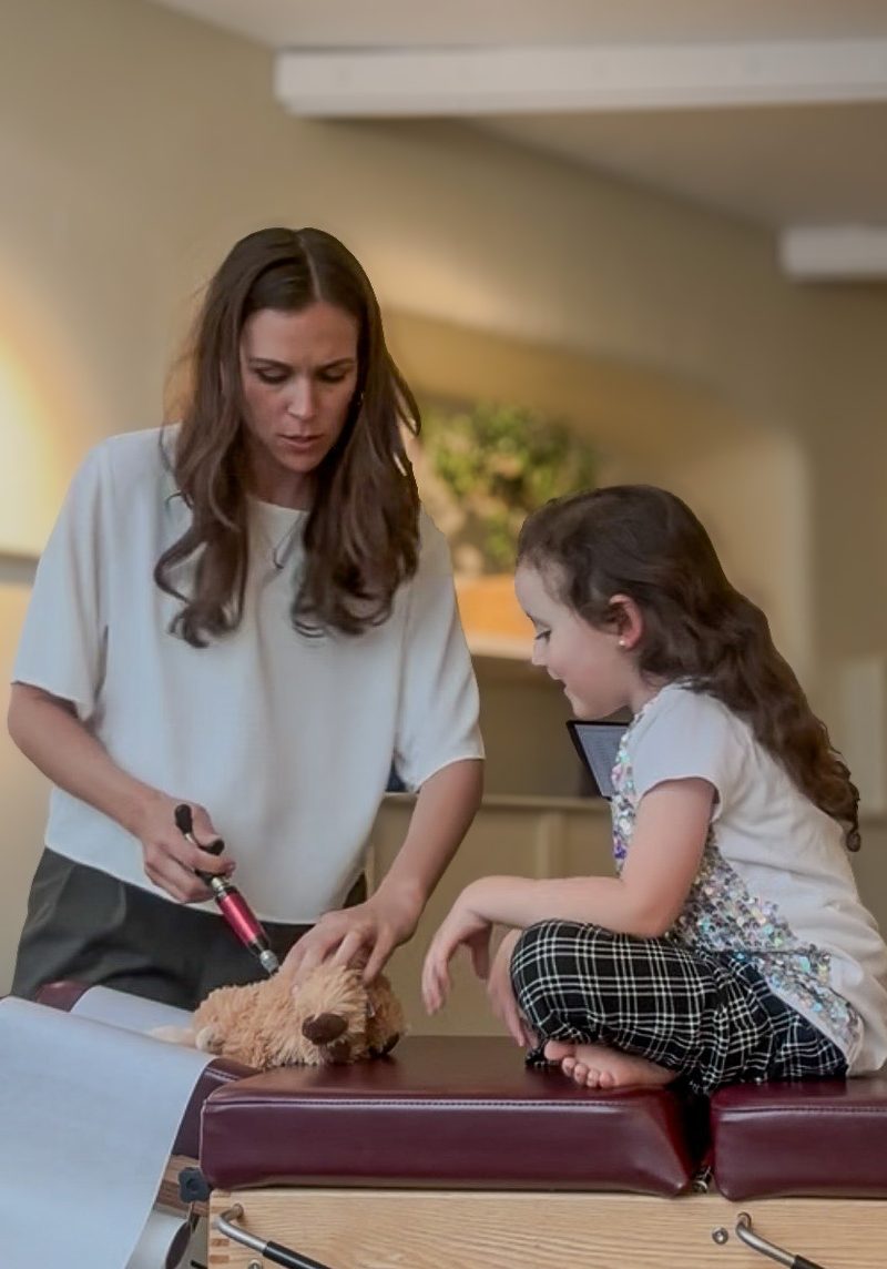 ruth with a young girl and babs on the treatment table